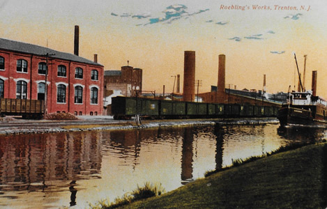The John A. Roebling wire rope works moved to Trenton in 1848, and by 1903 the plant employed 5,000 workers and covered 35 acres of the capital city.  The Roebling works was situated on a site which took advantage of both the Delaware and Raritan Canal and the Camden and Amboy Railroad.  This image shows a passenger train of the Camden and Amboy passing two canal steamboats near the Roebling works.  The impact of Roebling’s development of wire rope and its application to civil engineering can scarcely be overstated.  Roebling’s wire rope was used for the aqueducts of the Delaware and Hudson Canal, the inclined planes of the Morris Canal, as well many suspension bridges throughout the United States.  So significant was Roebling’s Trenton complex, it is thought to have inspired the motto on the Lower Trenton Bridge: “Trenton Makes, the World Takes.”